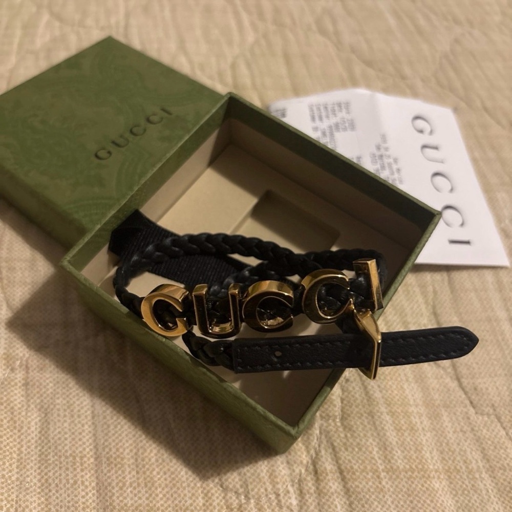 Gucci Black and Gold Logo double strap bracelet .